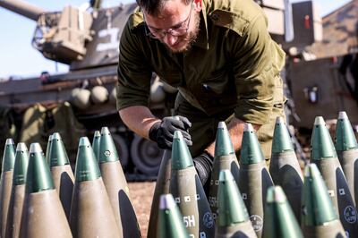 An Israeli soldier adjusts an artillery shell in the upper Galilee region. Israel and Hezbollah have exchanged gunfire and shells this week, leading to the deaths of five militants. AFP