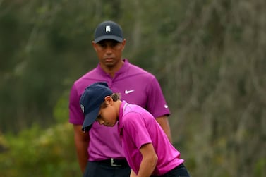 Tiger Woods and son Charlie line up a putt on the 14th hole during the first round of the PNC Championship at the Ritz Carlton Golf Club in Orlando, Florida. AFP