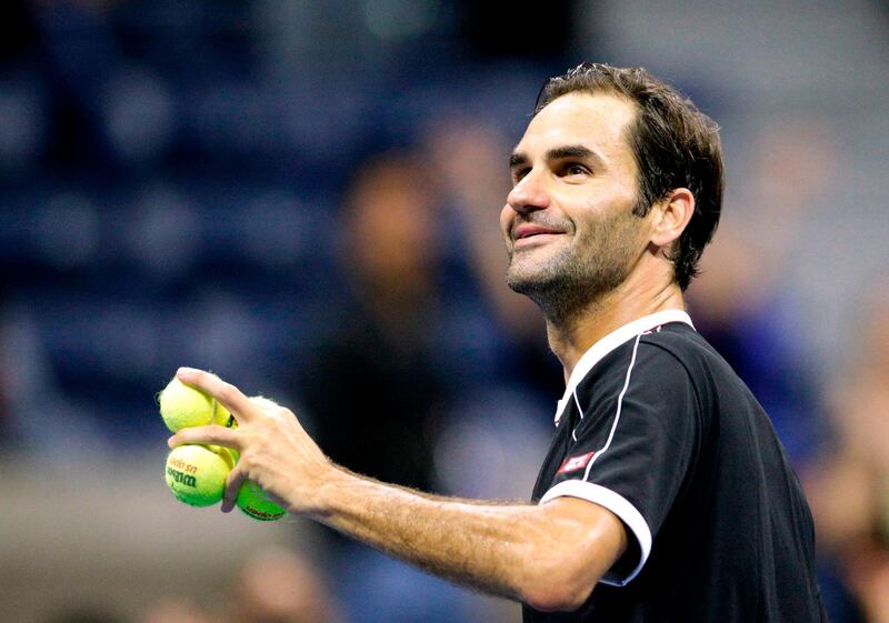 Roger Federer of Switzerland throws balls to members of the public after defeating Sumit Nagal of India at the US Open. AFP