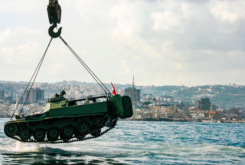 Environmental activists drop off an old mechanised armoured personnel carrier into the Mediterranean Sea off the coast of the southern Lebanese port city of Sidon, to create new habitat for marine life. Mahmoud Zayyat/AFP