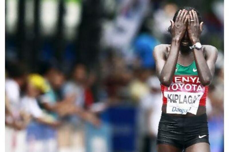 Edna Kiplagat reacts after winning the women's marathon in Daegu, South Korea.