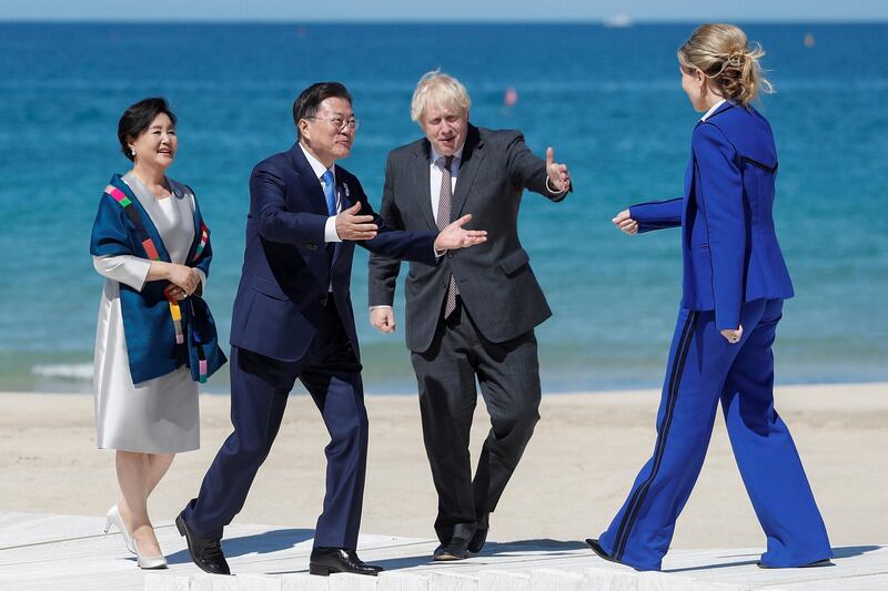 Britain's Prime Minister Boris Johnson and his wife Carrie Johnson, right, greet South Korea's President Moon Jae-in and South Korea's first lady Kim Jung-sook. AP
