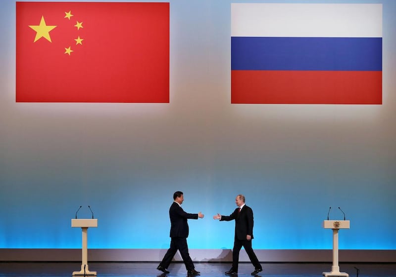 China’s President Xi Jinping, left, is welcomed by his Russian counterpart Vladimir Putin during an opening ceremony of “The Year of Chinese Tourism in Russia” in Moscow in 2013. Sergei Ilnitsky / AFP photo