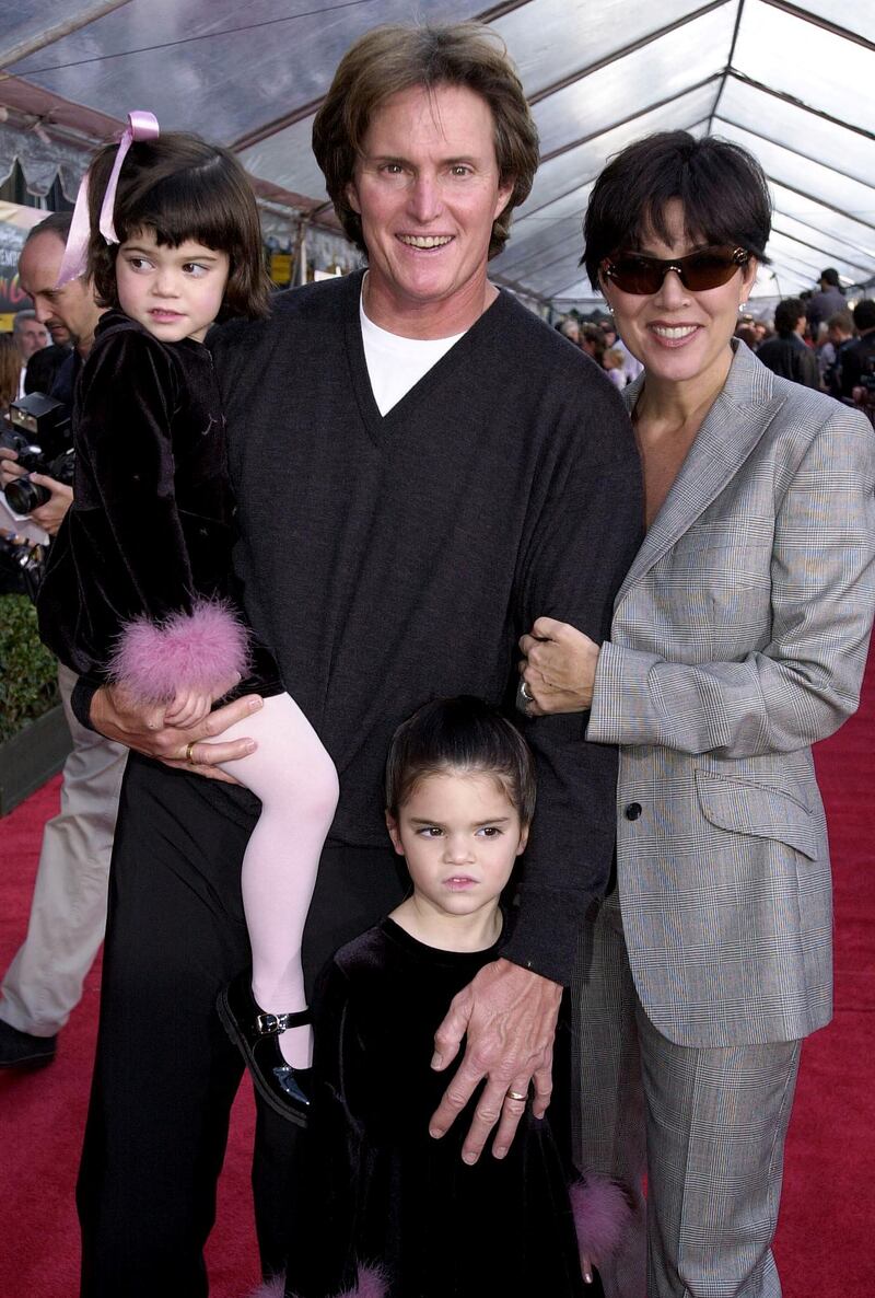 A young Kylie Jenner, wearing a black dress with pink fluffy cuffs, attends 'The Emperor's New Groove' premiere with her father Bruce, who is now known as Caitlyn Jenner, mother Kris Jenner and sister Kendall Jenner on December 10, 2000 in Hollywood. AFP