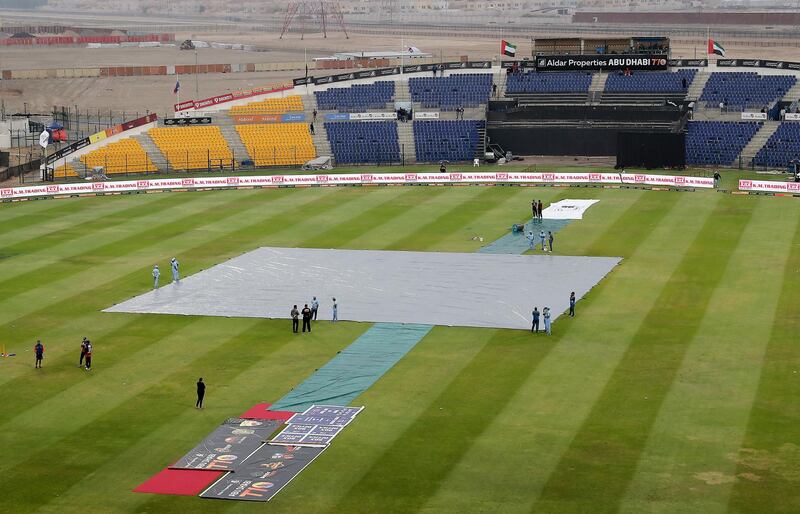 ABU DHABI , UNITED ARAB EMIRATES , Nov 20 – 2019 :- Ground staff covering the pitch after the rain during the Abu Dhabi T10 Cricket match between Maratha Arabians vs Karnataka Tuskers at Sheikh Zayed Cricket Stadium in Abu Dhabi. ( Pawan Singh / The National )  For Sports. Story by Paul