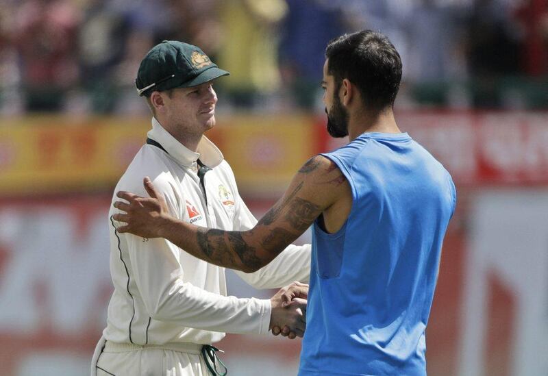 India captain Virat Kohli, right, shakes hands with Australia captain Steve Smith following the fourth and final Test match. Tsering Topgyal / AP Photo
