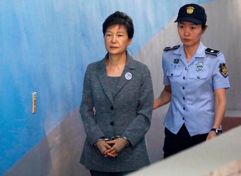 FILE - In this Aug. 25, 2017, file photo, former South Korean President Park Geun-hye, left, arrives for her trial at the Seoul Central District Court in Seoul, South Korea. A South Korean has sentenced disgraced ex-President Park to 24 years in prison over a corruption scandal. The Seoul Central District Court issued the verdict on Friday, April 6, 2018,  after convicting Park of bribery, abuse of power, extortion and other charges. Park has been held at a detention center near Seoul since her arrest in March 2017, but she refused to attend Fridayâ€™s court session citing sickness. (Kim Hong-Ji/Pool Photo via AP, File)
