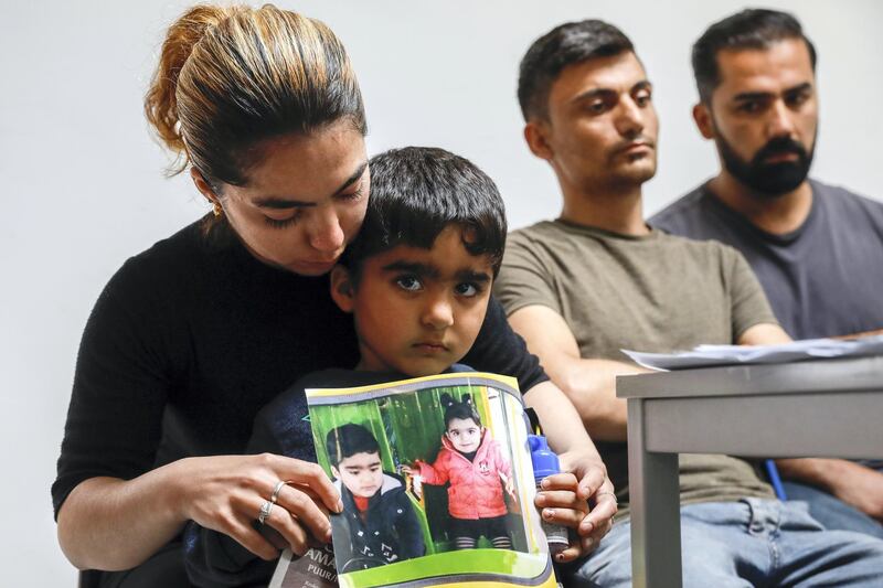 (FILES) In this file photo taken on May 21, 2018, the mother of Mawda Shawri, a two-year-old girl of Kurdish origin who died after police gave chase to a van carrying illegal migrants in Belgium, shows a picture of her daughter (R) during a press conference of "Solidarity for All" regarding the death of Mawda Shawr, in Brussels. - A Belgian police officer will appear in court on November 23, 2020, in the trial regarding the death of Mawda Shawri. The child died in the ambulance on her way to hospital in the night of May 16 and 17, 2018, after a police pursuit in Maizieres, near Mons, when she was hit by a police bullet while she was in a van with illegal immigrants. (Photo by THIERRY ROGE / BELGA / AFP) / Belgium OUT