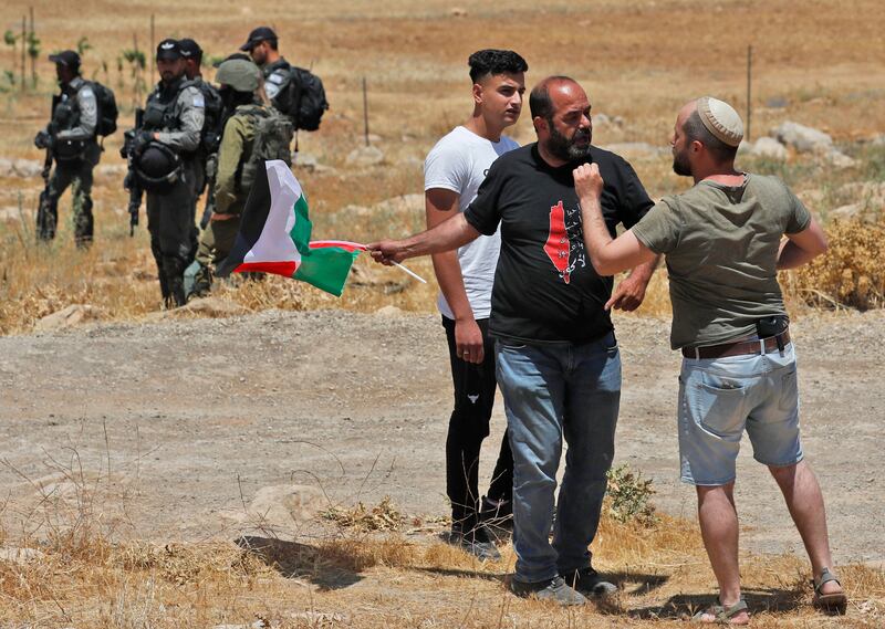 A Jewish settler scuffles with a Palestinian demonstrator in the West Bank city of Hebron. AFP
