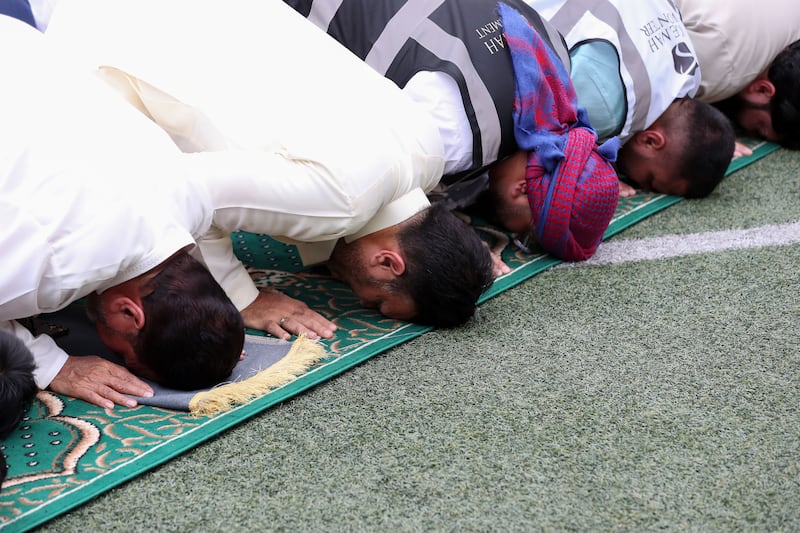 Muslim worshippers perform prayers on the first day of Eid