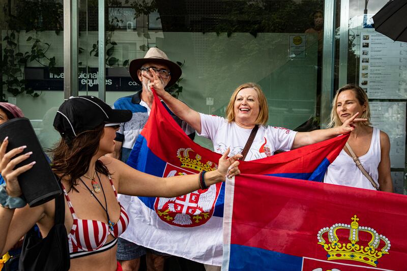 Supporters holding Serbia flags gather outside Park Hotel where Novak Djokovic was taken pending his removal from the country. Getty Images