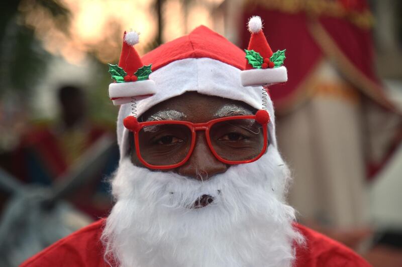 A Haitian man in a Santa Claus costume participates in a Christmas Parade (Parad Nwel in Haitian creole) on the streets of the commune of Petion Ville, in the Haitian capital Port-au-Prince. AFP