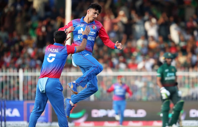 Afghanistan bowler Mujeeb Ur Rahman celebrates after taking the wicket of Bangladesh's Mohammad Naim for six.