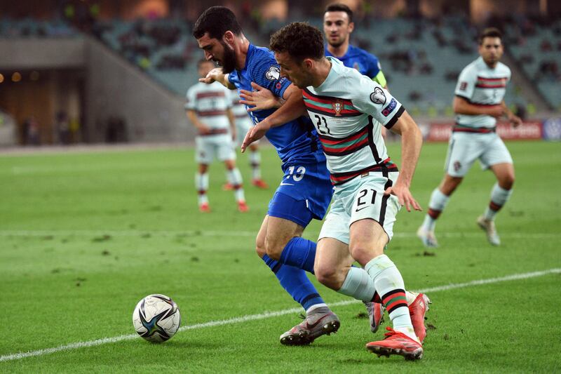 Azerbaijan defender Abbas Huseynov and Portugal's Diogo Jota vie for the ball.