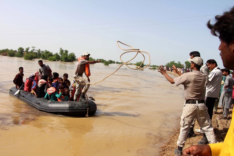 Personnel from the Pakistan Navy rescue people from the floods in the Dadu district of Farid Abad village in Sindh province. EPA