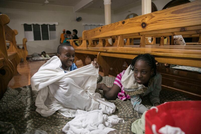 Kids play at a shelter in a local church during the evening before the arrival of Hurricane Irma in Las Terrenas, Dominican Republic, on September 6, 2017.  Tatiana Fernandez / AP