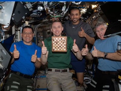 Sultan Al Neyadi with his colleagues aboard the space station during a game of chess. Photo: Nasa