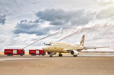 The first flight gets a water cannon salute at Baku's Heydar Aliyev International Airport. Etihad Airways