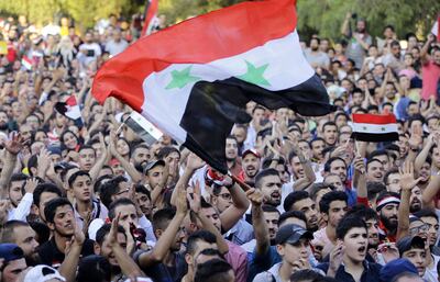 Syria football fans watch the FIFA World Cup 2018 qualification football match between Iran and Syria on a large screen at the Al-Jalaa stadium in Damascus on September 5, 2017.
For the first time in Syria's conflict, sport has come to the defence of the deeply-fractured country's unity, with regime backers and foes alike dreaming of World Cup 2018 qualification. / AFP PHOTO / LOUAI BESHARA