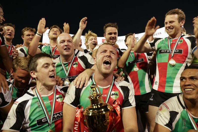 Ben Bolger, front and centre, and his Abu Dhabi Harlequins teammates celebrate after beating Jebel Ali Dragons to win the UAE Premiership. Victor Besa for The National