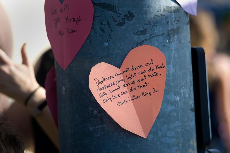 Paper hearts with messages of support are visible at an intersection next to the Chabad of Poway synagogue. EPA