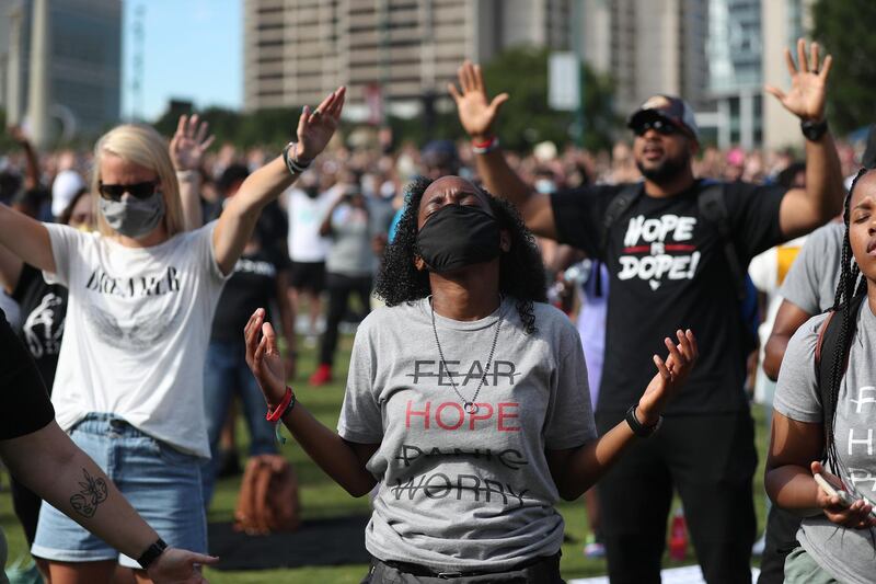 People pray together during a Juneteenth event organized by the One Race Movement in Atlanta, Georgia. AFP