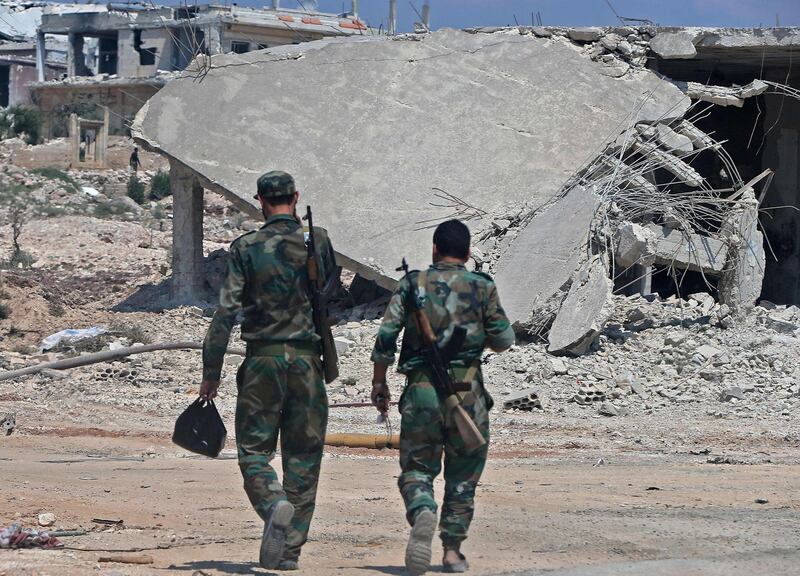 Syrian government forces gather near the town of Khan Shaykhun in the southern countryside of the rebel-held Idlib province on August 18, 2019. A Turkish military convoy crossed into jihadist-run northwest Syria on August 19, it's path blocked by advancing regime troops as tensions soared between Damascus and Ankara, which said its forces were targeted by an air strike. / AFP / -
