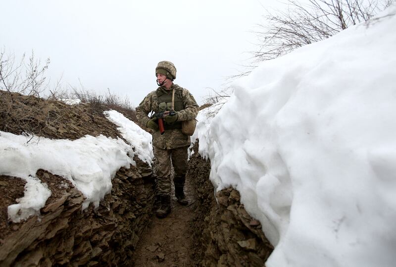 An Ukrainian serviceman walks in a trench on the frontline of the conflict with pro-Russian separatists in eastern Ukraine, where underfoot conditions are said to be soft. AFP