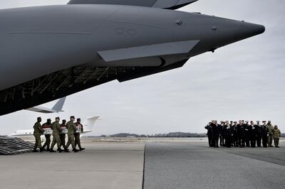 US President Donald Trump, US Secretary of State Mike Pompeo and others watch as the remains of Scott A. Wirtz, a Defense Intelligence Agency civilian and former Navy Seal, are carried by during a dignified transfer for US personal killed in a suicide bombing in Syria,  at Dover Air Force Base January 19, 2019 in Dover, Delaware.  / AFP / Brendan Smialowski
