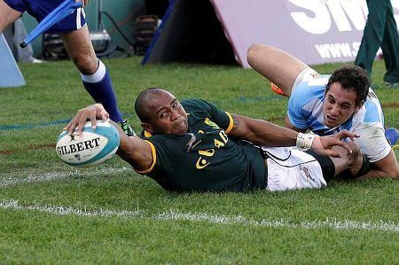 South Africa's Cornal Hendricks, left, scores a try against Argentina as he is tackled by Argentina's Joaquin Tuculet during their Rugby Championship match in Salta, Argentina, Saturday, Aug. 23, 2014. (AP Photo/Victor R. Caivano)