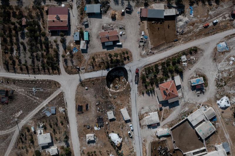 An aerial view of a sinkhole that has swallowed a section of road in the village of Ekmekci in Karapinar, Turkey. Illegal wells have caused groundwater levels to fall, leaving the area vulnerable to sinkholes. Getty Images