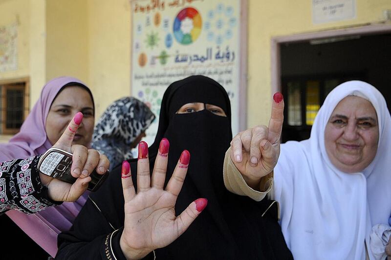 Egyptian women show their ink-stained fingers after casting their vote on the second day of Egypt’s presidential election in the Mediterranean port city of Alexandria. AFP