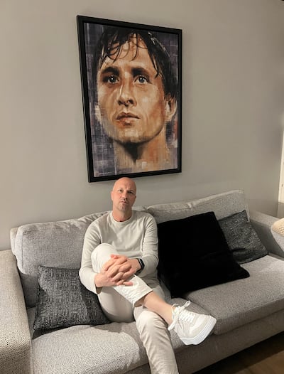 Jordi Cruyff sits under a picture of his father, Johan Cruyff, at his home in Barcelona. Photo: Andy Mitten