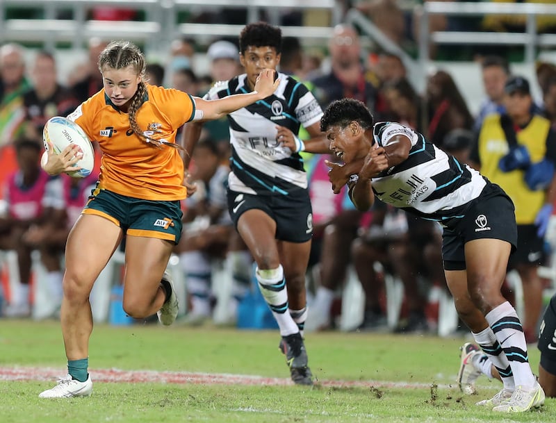 Australia's Lily Dick breaks though the Fiji defence in the Dubai Sevens final.