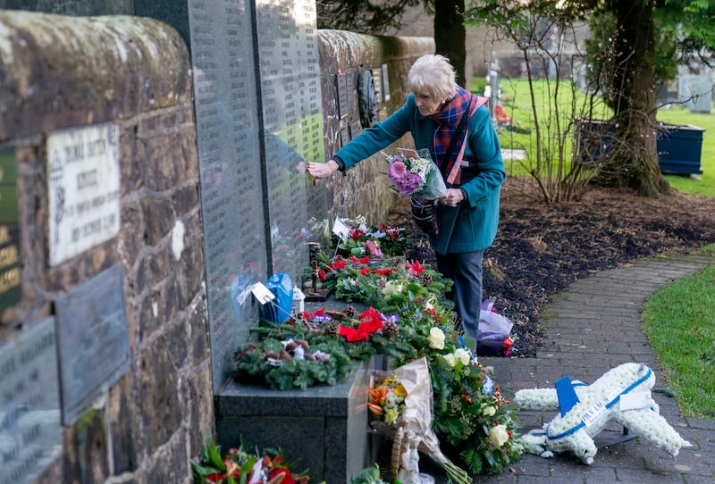 Josephine Donaldson lays flowers in the Memorial Garden at Dryfesdale Cemetery, Lockerbie, to mark the 35th anniversary of the bombing. AP