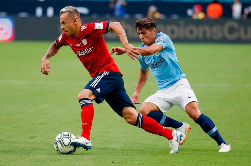 Bayern Munich's Rafinha vies for the ball with Manchester City's  Patrick Roberts. AFP