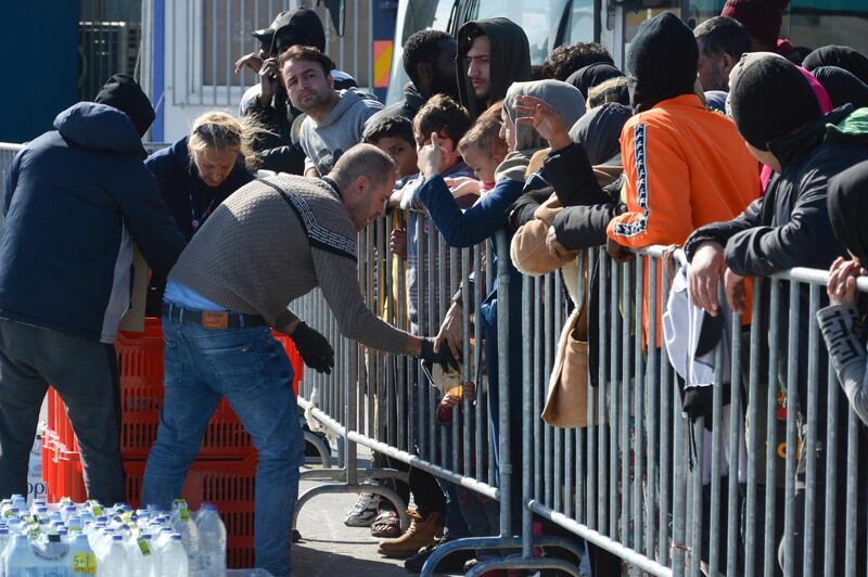 Migrants wait in line for food and water distribution at the port of Mytilene on the northeastern Aegean island of Lesbos, Greece. AP Photo
