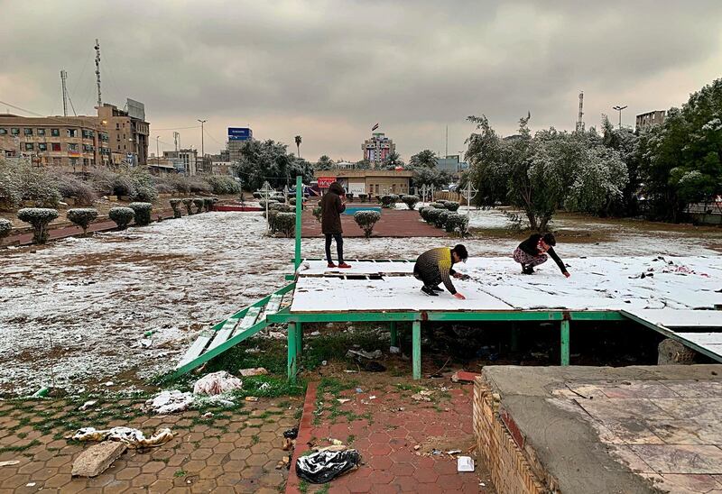 People play in the fresh snow in Baghdad, Iraq. AP Photo