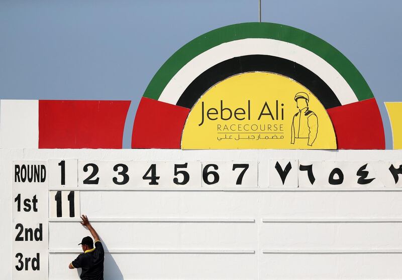 Dubai, United Arab Emirates - November 01, 2019: A man marks on the board the winner Lady Parma ridden by Richard Mullen of the Orient Irrigation Service race on the opening meeting at Jebel Ali racecourse. Friday the 1st of November 2019. Jebel Ali racecourse, Dubai. Chris Whiteoak / The National