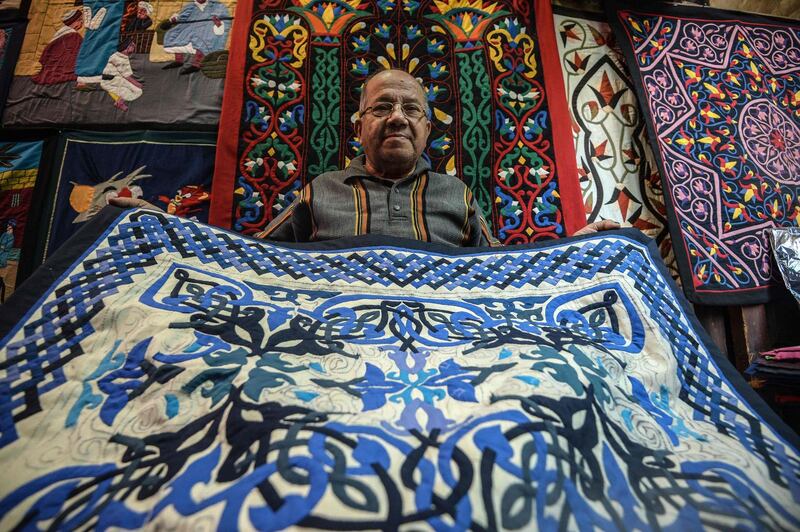 A craftsman showcases a tapestry at his shop in Khayamiya Street, in Cairo, Egypt. AFO