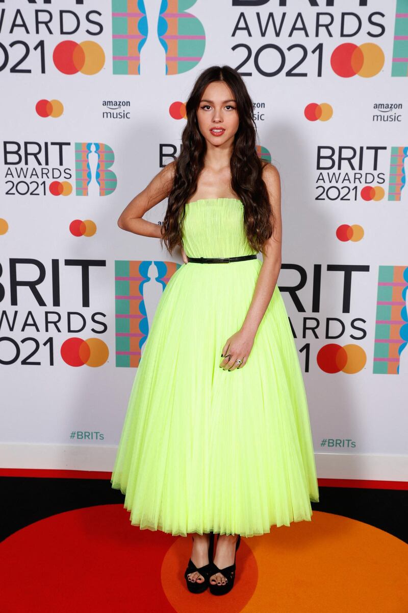 In a handout picture released by the Brit Awards Olivia Rodrigo poses on the red carpet on arrival for the BRIT Awards 2021 in London on May 11, 2021. (Photo by John Marshall / John Marshall / AFP) / RESTRICTED TO EDITORIAL USE – NO POSTERS – NO MERCHANDISE– NO USE IN PUBLICATIONS DEVOTED TO ARTISTS - - NO ARCHIVE - NO SALES - NO USE AFTER **JUNE 8, 2021**