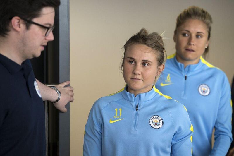 Manchester City Women’s Football Club players Izzy Christiansen (C) and Steph Houghton (R) arrives to meet the media at the City Football Academy on Sunday. Oli Scarff / AFP