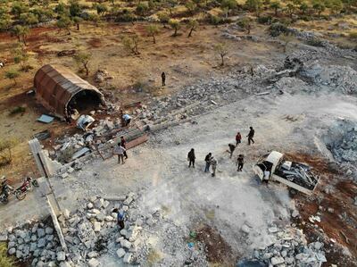 TOPSHOT - An aerial view taken on October 27, 2019 shows the site that was hit by helicopter gunfire which reportedly killed nine people near the northwestern Syrian village of Barisha in the Idlib province along the border with Turkey, where "groups linked to the Islamic State (IS) group" were present, according to a Britain-based war monitor with sources inside Syria.  The helicopters targeted a home and a car on the outskirts of Barisha, the Syrian Observatory for Human Rights said, after US media said IS leader Abu Bakr al-Baghdadi was believed to be dead following a US military raid in the same province. Observatory chief Rami Abdel Rahman said the helicopters likely belonged to the US-led military coalition that has been fighting the extremist group in Syria. / AFP / Omar HAJ KADOUR
