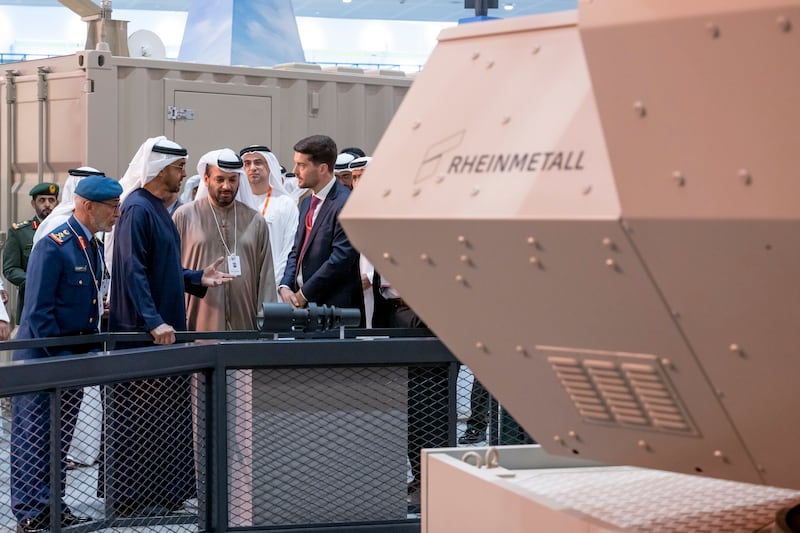 Sheikh Mohamed, Lt Gen Al Mazrouei and Faisal Al Bannai, chief executive of UAE defence conglomerate Edge, visit a pavilion at the exhibition