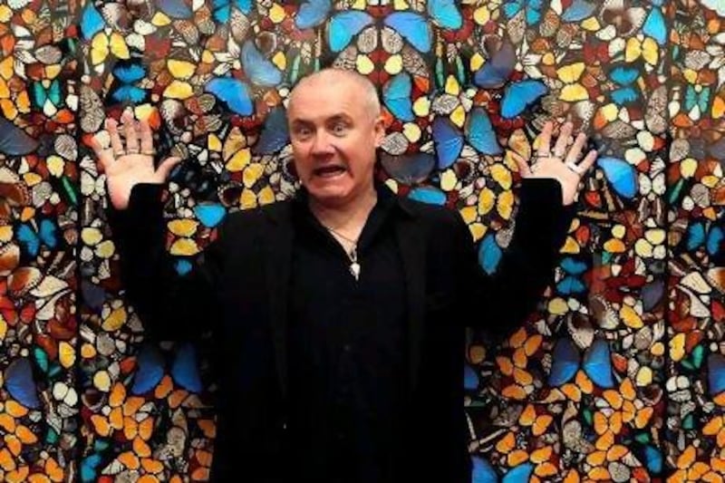 The British artist Damien Hirst poses in front of his painting The Importance of Elsewhere - The Kingdom of Heaven. Kerim Okten / EPA