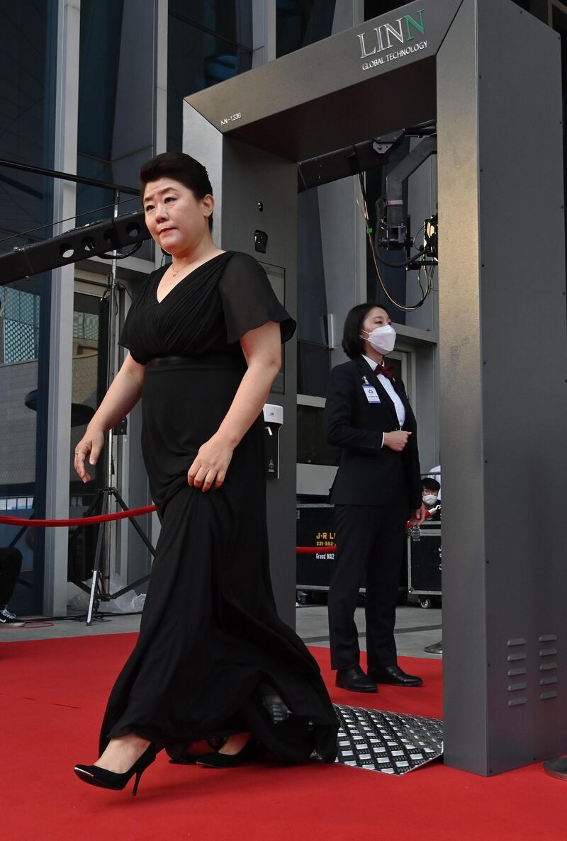 Actress Lee Jeong-eun walks through a thermal camera system to check her body temperature as she arrives on the red carpet. AFP