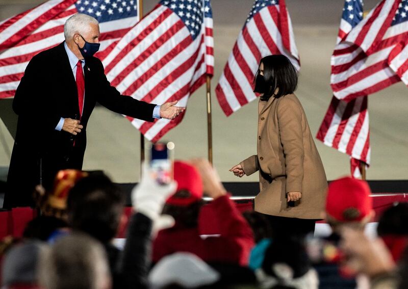 Vice President Mike Pence motions to his daughter Audrey Pence to walk on stage after he spoke during a campaign top on behalf of President Donald Trump on Wednesday, Oct. 28, 2020, in Flint, Mich. (Nicole Hester/Ann Arbor News via AP)