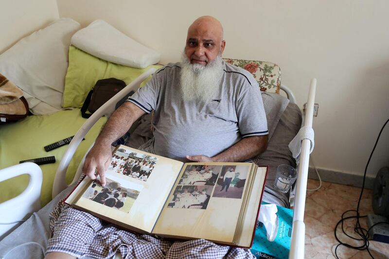 ABU DHABI,  UNITED ARAB EMIRATES , JUNE 17 – 2019 :- Mohammed Ishaq a player in the UAE's 1996 World Cup side, who is now wheelchair bound showing newspapers clipping at his home in Abu Dhabi. He is on wheelchair since a car crash in 2009. ( Pawan Singh / The National ) For Sport. Story by Paul