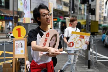 Suporters campaign for Susi Law, a candidate in district council elections in Hong Kong. Reuters