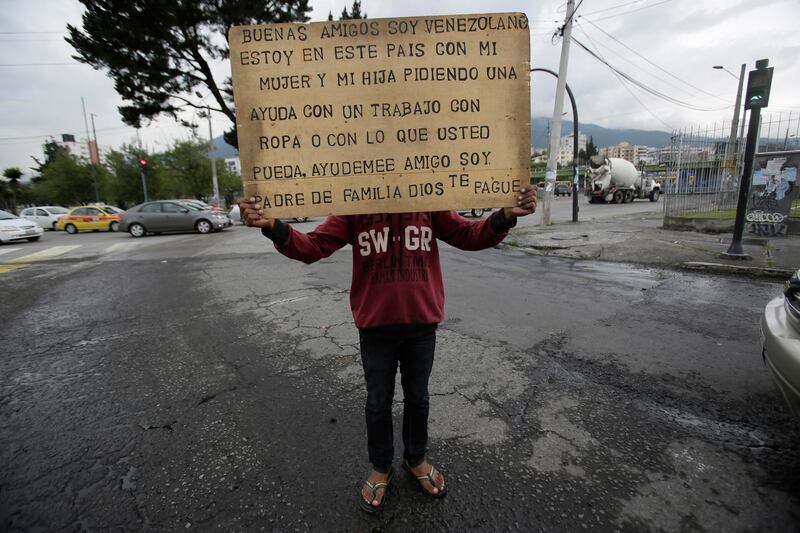 Jose Perez holds a sign that reads in Spanish â€œGood afternoon, I am Venezuelan. I am in this country with my wife and daughter asking for help. A job, clothing, or with anything you can. Please help. I am a father. May God repay you,â€ at a street corner in Quito, Ecuador, Thursday, Nov. 22, 2018. According to the United Nations, over three million Venezuelans have migrated in recent years.  (AP Photo/Dolores Ochoa)